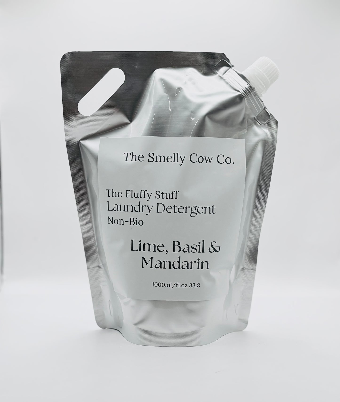 A silver pouch with a minimalist label containing laundry detergent, scented in lime, basil and mandarin.
