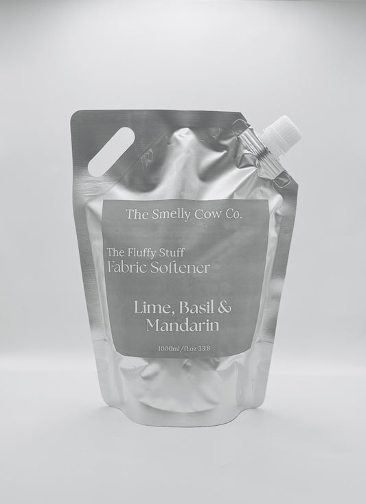 A silver pourable pouch with a minimalist label with lime, basil and mandarin scented fabric conditioner inside.