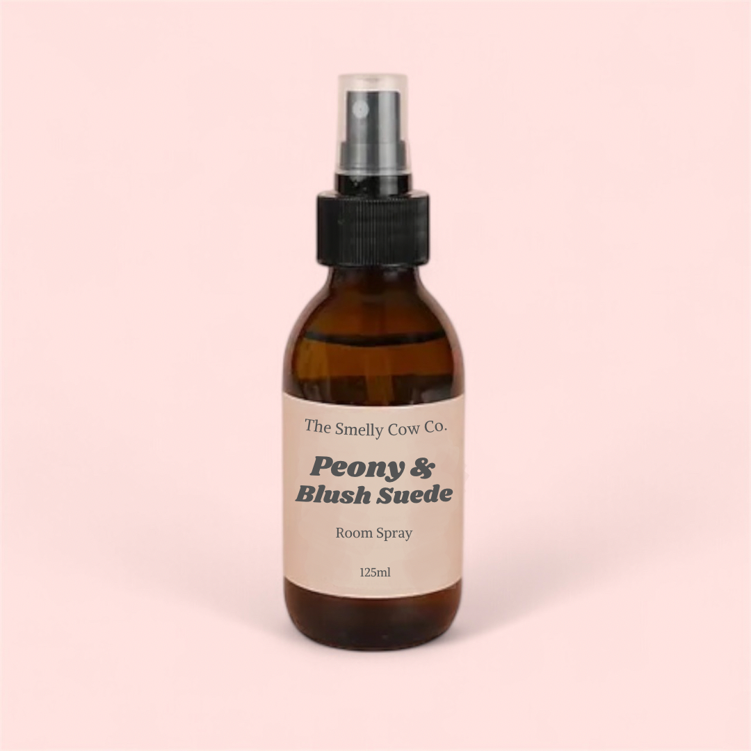 An 120ml amber bottle with peony and blush suede room spray inside.